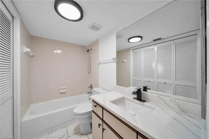 Guest Bathroom with closet to washer and dryer, Bathtub / shower combination, Granite counter, New faucet, Lighting and Tile floor