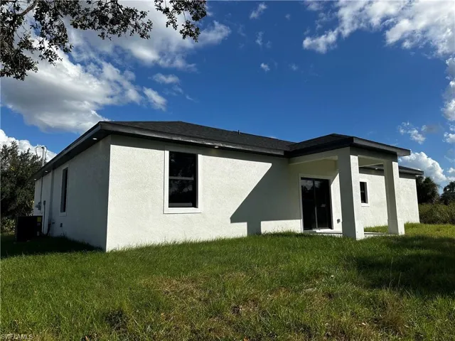 Rear view of house with a lawn