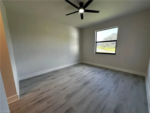 Empty room with light wood-type flooring and ceiling fan