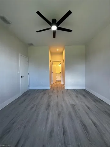 Spare room with hardwood / wood-style floors and ceiling fan