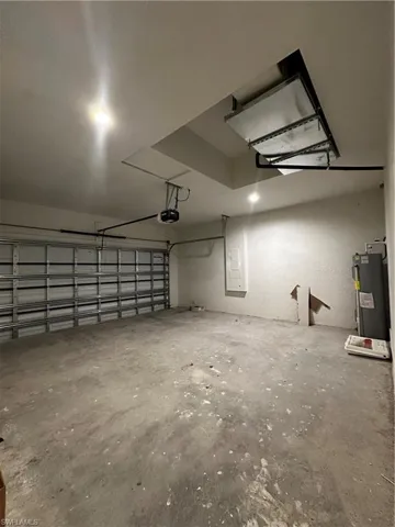 Garage with water heater and a garage door opener