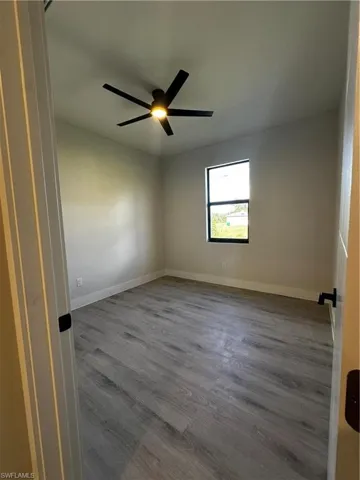 Spare room featuring hardwood / wood-style floors and ceiling fan