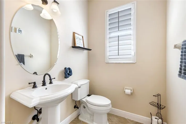 Well appointed powder room, just off the foyer.