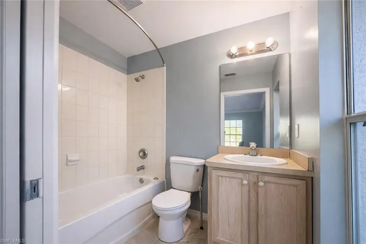 Full bathroom featuring vanity, bathtub / shower combination, and light tile patterned flooring