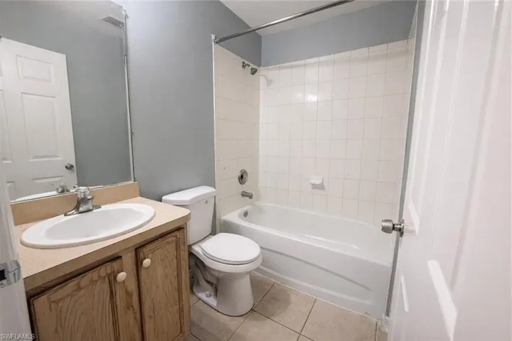 Full bathroom featuring vanity, shower / tub combination, and light tile patterned floors
