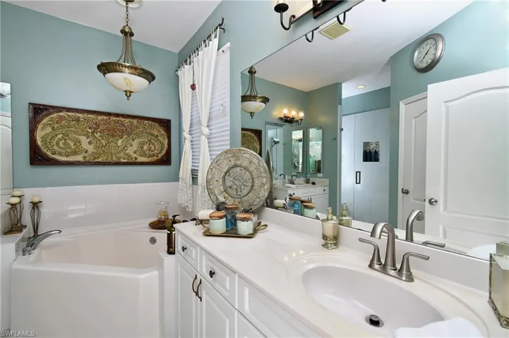 Bathroom with vanity and plus walk in shower