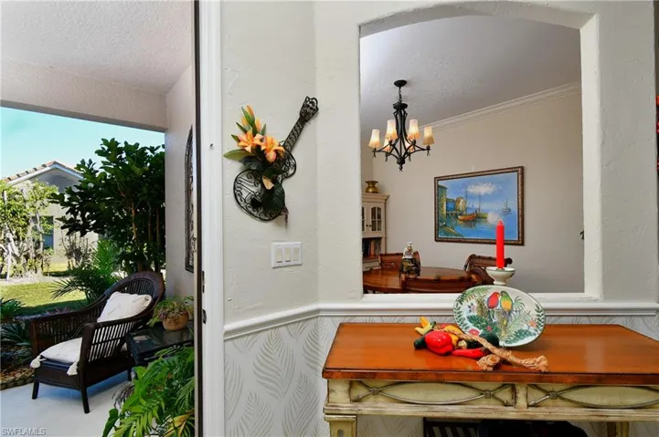 Dining area featuring ornamental molding, a textured ceiling, and an inviting chandelier