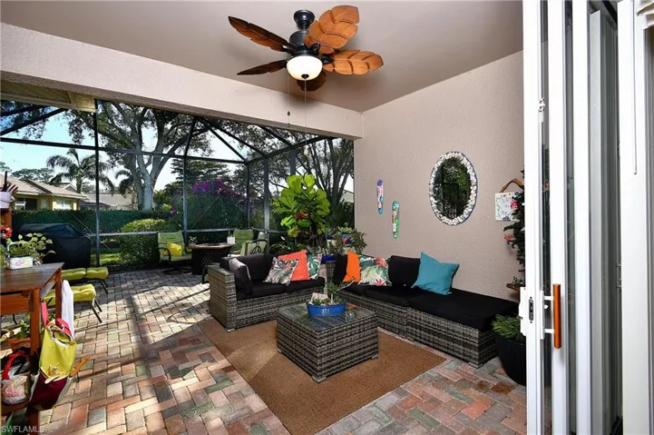 View of patio / terrace with outdoor lounge area, ceiling fan, and glass enclosure