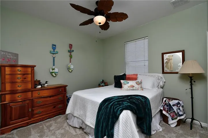 Carpeted bedroom with ceiling fan