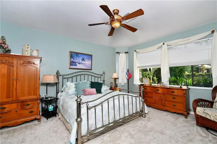 Bedroom featuring light carpet and ceiling fan