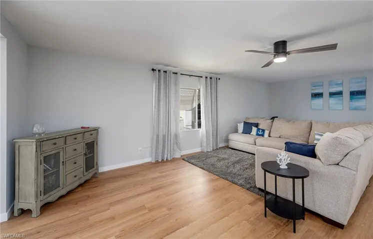 Living room featuring light hardwood / wood-style floors and ceiling fan