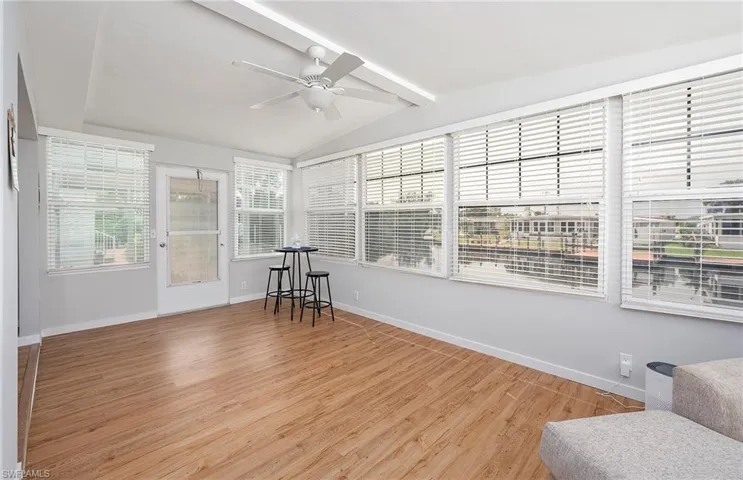 Sunroom featuring ceiling fan and vaulted ceiling with beams