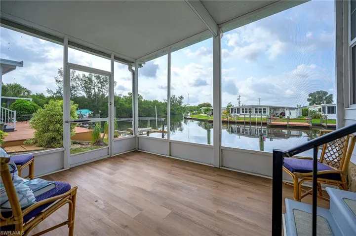 Sunroom / solarium featuring a water view