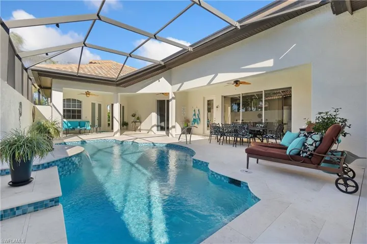 View of swimming pool with a patio, a lanai, and ceiling fan