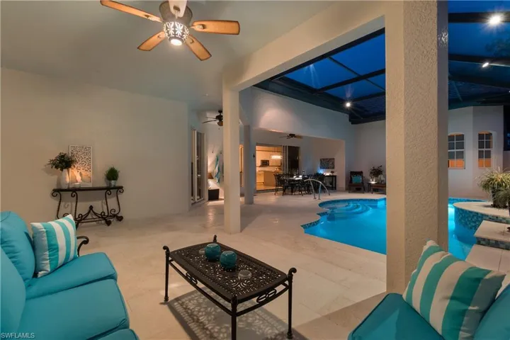 View of swimming pool featuring ceiling fan