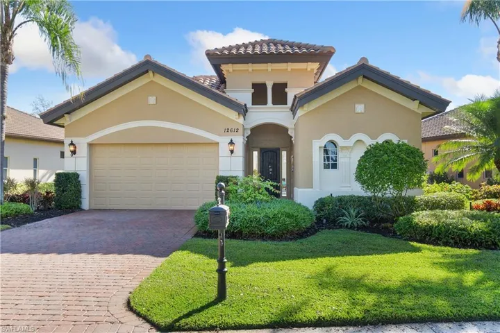 Mediterranean / spanish-style home with a garage and a front yard