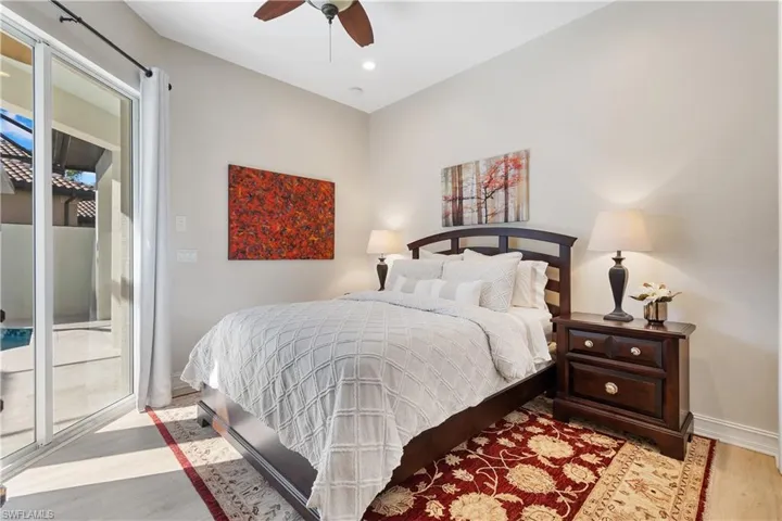 Bedroom with ceiling fan, access to exterior, and light wood-type flooring