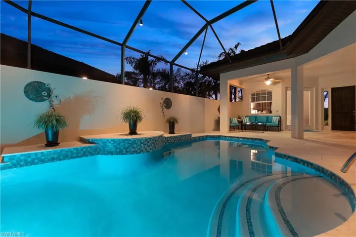 Pool at dusk with an outdoor living space, a patio, a lanai, and ceiling fan