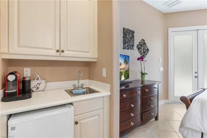Kitchen featuring dishwasher, sink, and light tile patterned floors
