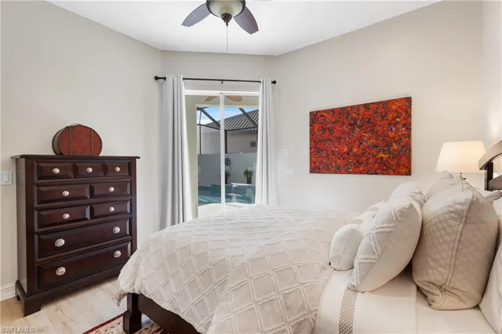 Bedroom with ceiling fan, access to outside, and light hardwood / wood-style floors