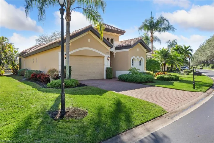 Mediterranean / spanish-style house featuring a garage and a front yard