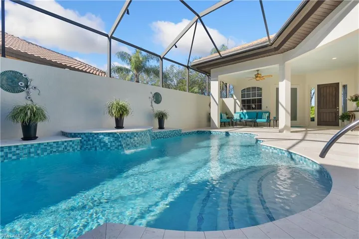 View of swimming pool with a lanai, ceiling fan, a patio, an outdoor hangout area, and pool water feature