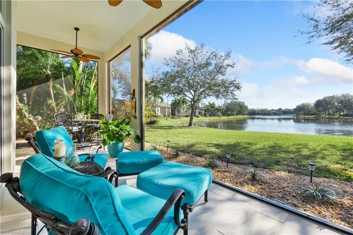Unfurnished sunroom featuring a water view and ceiling fan