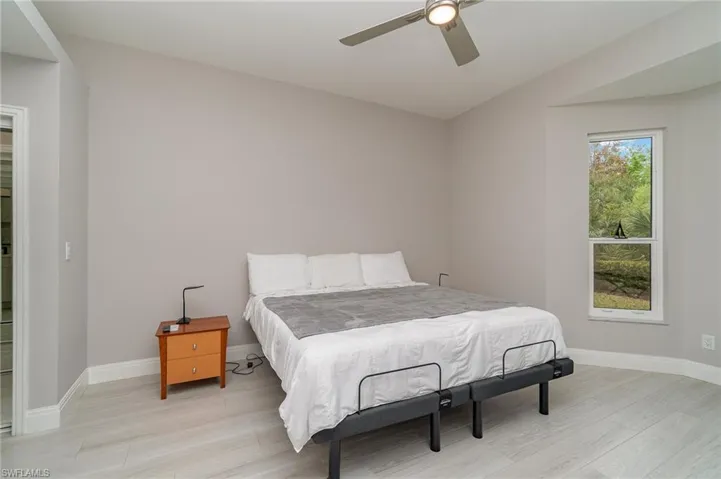Primary Bedroom featuring light tile flooring and ceiling fan