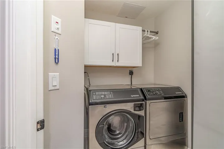Laundry Room featuring cabinets and washing machine and dryer
