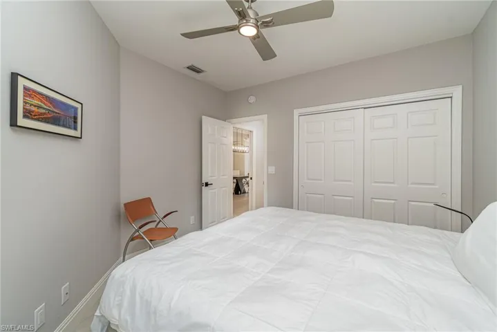Guest Bedroom with ceiling fan and a closet
