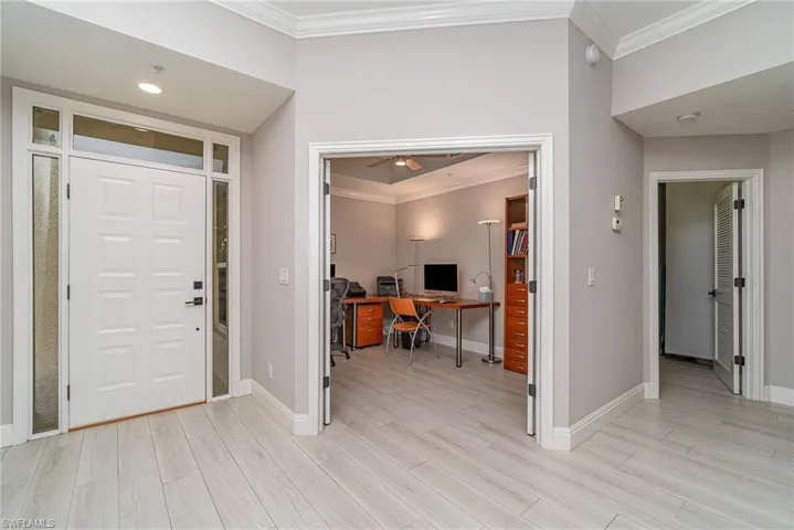 Foyer featuring crown molding and light tile flooring