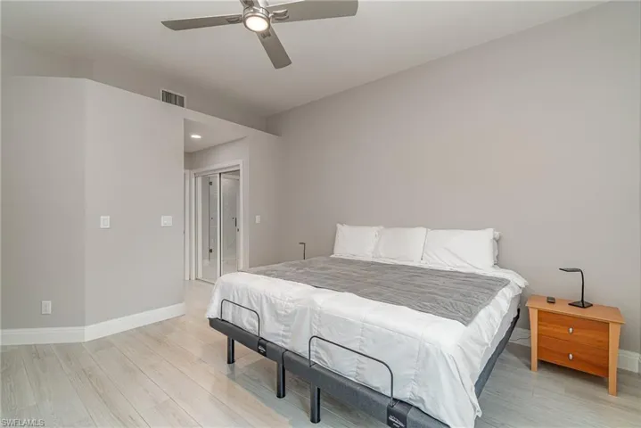 Primary Bedroom featuring light tile flooring, ceiling fan, and a closets