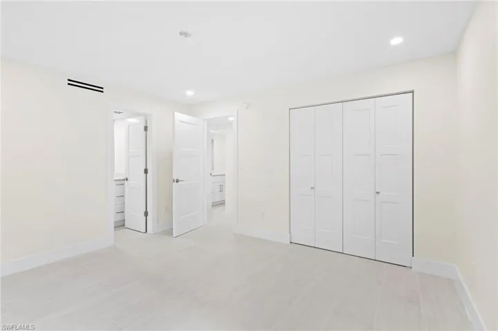 Unfurnished bedroom with a closet and ensuite bath