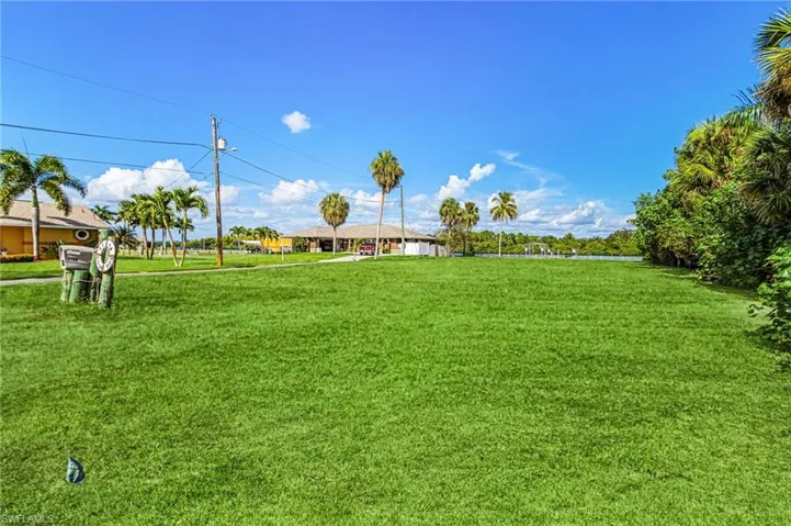 Grass has been virtually staged. Lot is mainly dirt