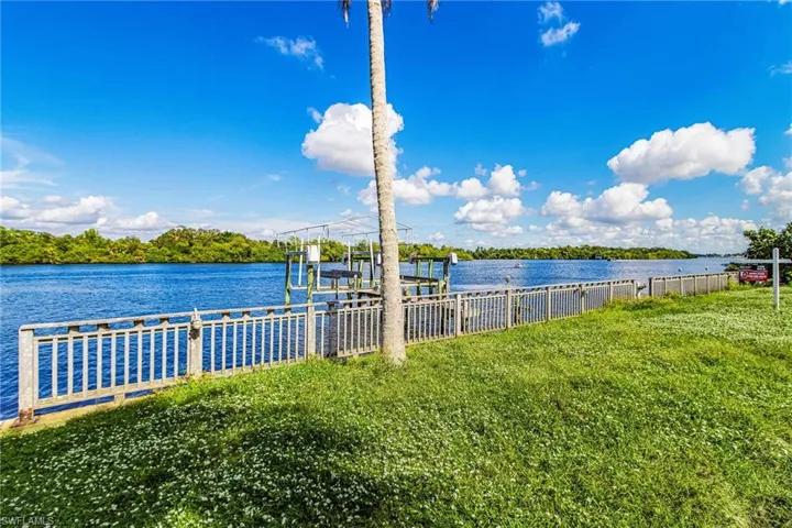 Dock with boat lift and a water view