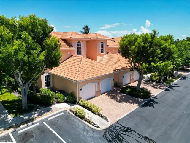 View of front of property featuring stucco siding, a garage, and a tile roof