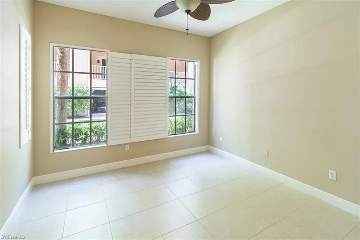 Unfurnished room featuring ceiling fan and light tile patterned floors