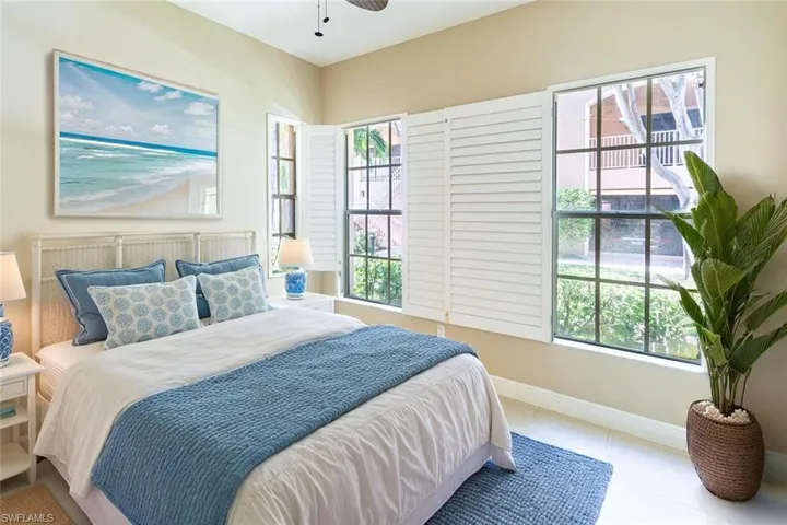 Tiled bedroom featuring baseboards and ceiling fan