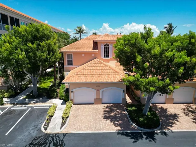 Mediterranean / spanish house featuring a tiled roof, stucco siding, and driveway