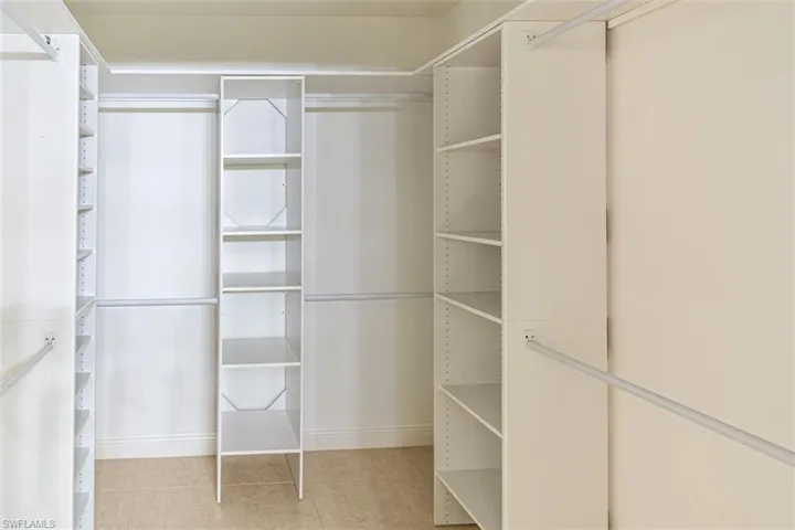 Walk in closet featuring light tile patterned floors