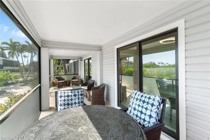Sunroom with outdoor dining space and an outdoor hangout area