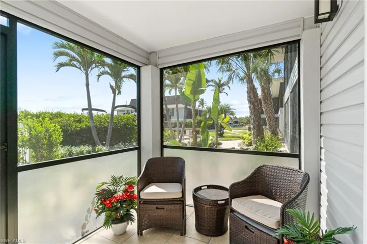 Sunroom with tile patterned floors and plenty of natural light