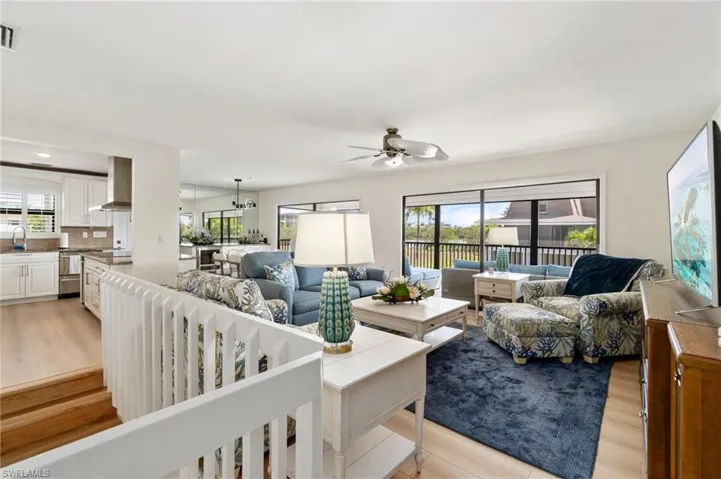 Living area with light wood finished floors and a ceiling fan