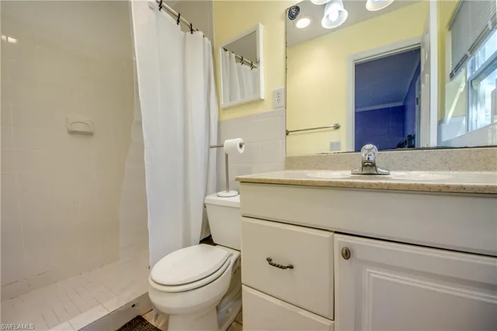 Full bath with vanity and tiled shower