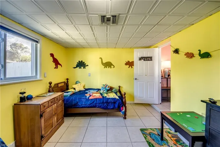 Bedroom featuring light tile patterned floors and baseboards