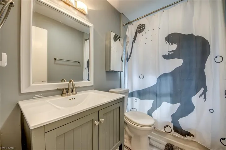 Bathroom with curtained shower and vanity
