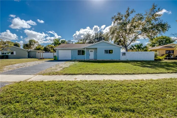 Single story home with driveway, stucco siding, and an attached garage