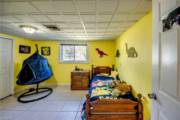 Bedroom with an ornate ceiling and tile patterned floors