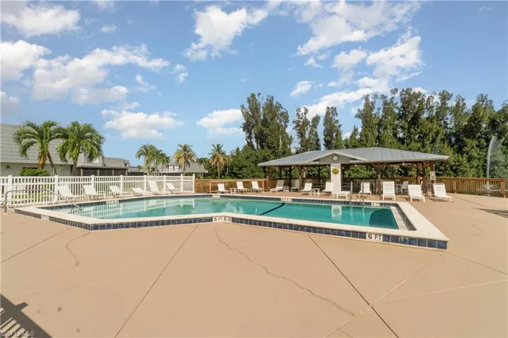 Community pool with a patio