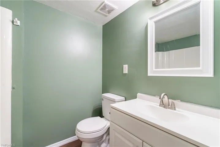 Bathroom featuring vanity and a shower